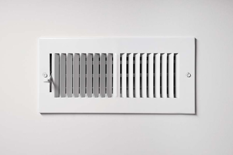 ac definitions, A heating/cooling vent register on the wall of a home, with open/close lever