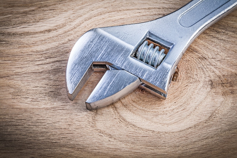 Blog Image : 4 Important Heat Pump Maintenance Tips Photo: wrench on wood table
