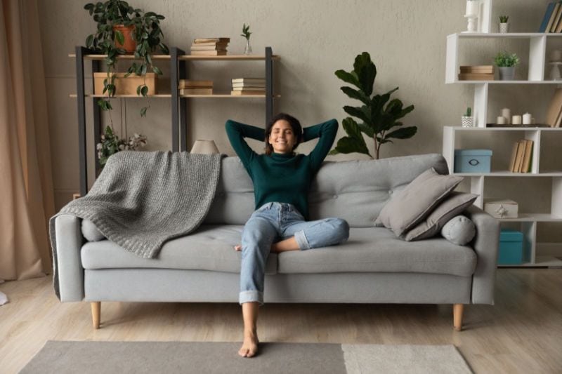 How a Whole-House Humidifier Keeps You Healthy - Woman Sitting in Air Conditioned Home.