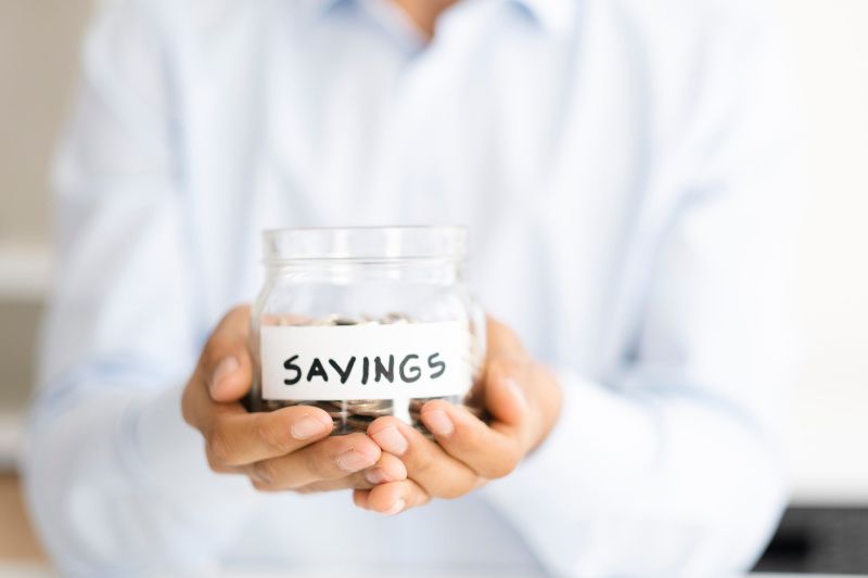 Why Buying a Heat Pump Instead of a Furnace Makes Sense - Two Hands Holding a Savings Jar.