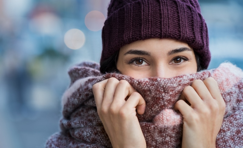 Woman in scarf looking at camera.